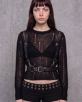 Harnais ceinture Éris en cuir vegan noir porté sur un pull ajouré noir, vue de face